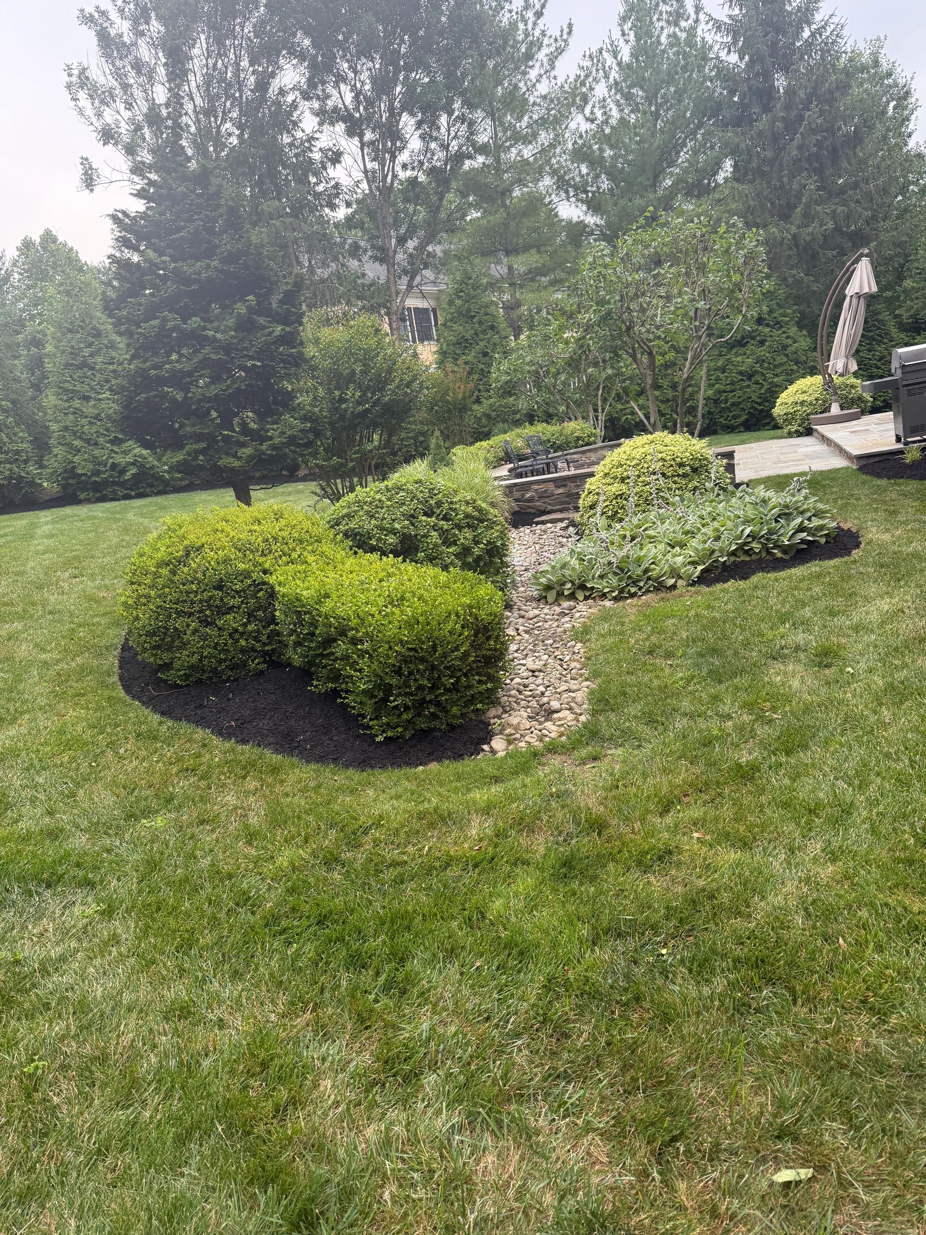 Landscape bed with boulder accents