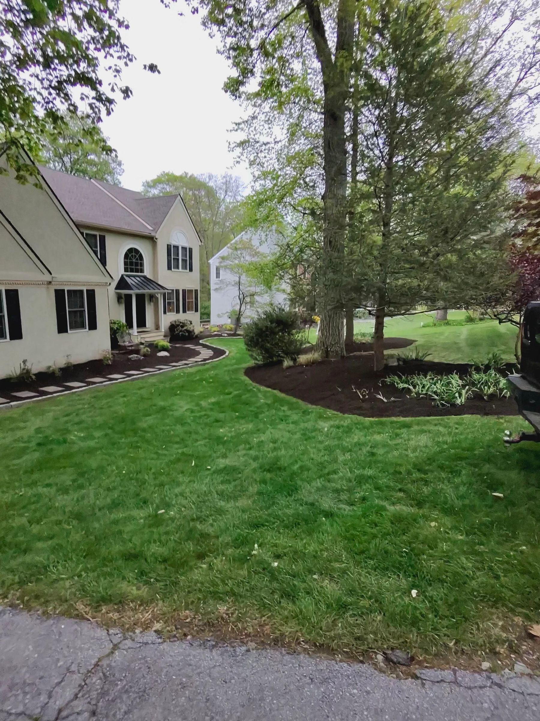 Front yard landscaping with mulch and shrubs