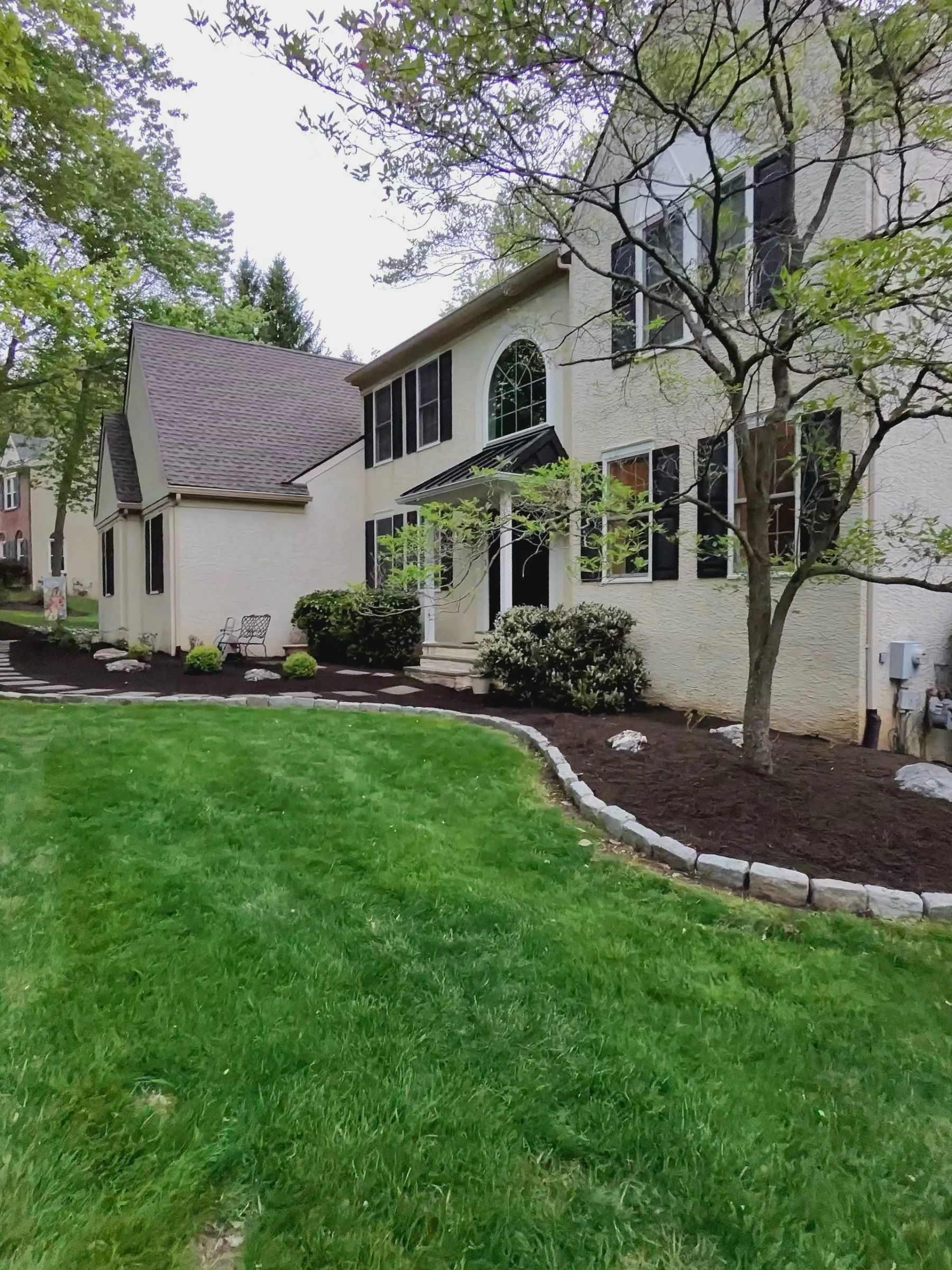 Landscaping in Chester County, PA — mulched front bed with stone edging by Castillo Earthworks